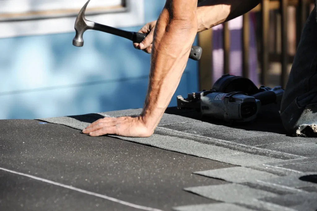 man repairing roof